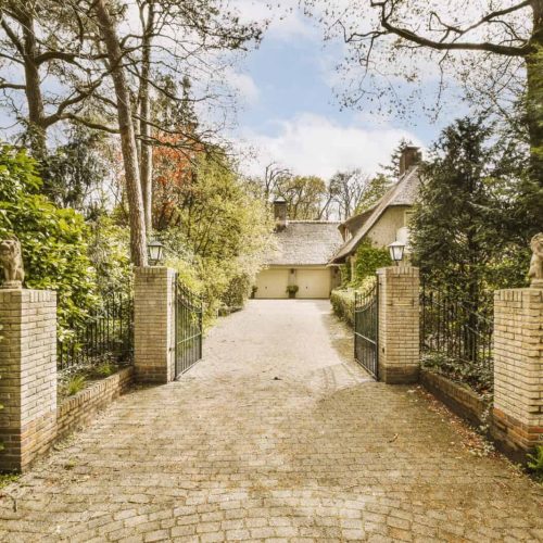 a house with a driveway and a gate and a