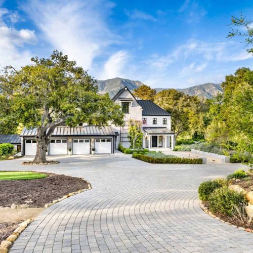 this home has brick driveways and driveways in front of it